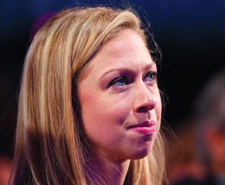 FILE - This Sept. 23, 2012 file photo shows Chelsea Clinton listening to her father, former President Bill Clinton speak during the Clinton Global Initiative, in New York. Former first daughter Chelsea Clinton has signed on to help promote President Barack Obama's inaugural kick-off event to get Americans across the country engaged in serving their communities. Inaugural planners announced Tuesday that Clinton will be honorary chair of the National Day of Service, the president's call for Americans to honor the legacy of Dr. Martin Luther King Jr. on the holiday weekend celebrating his birthday. (AP Photo/Mark Lennihan, File)