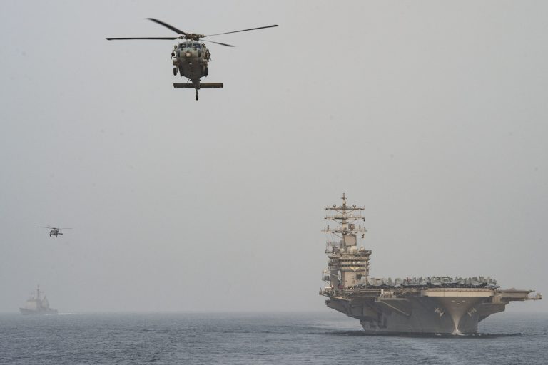 An MH-60 Seahawk helicopter flies from the carrier Dwight D. Eisenhower on Nov. 22 in the Persian Gulf. Four days later, an Iranian boat pointed its weapon at an MH-60 over the Strait of Hormuz. (Navy photo)
