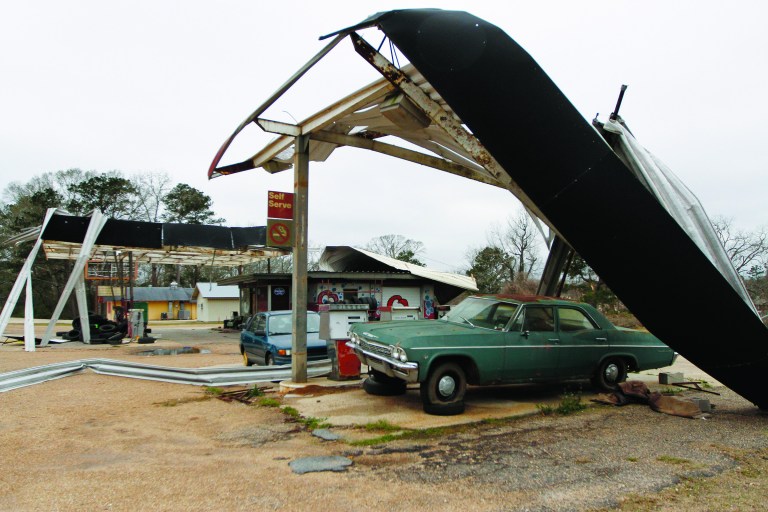 Large metal awnings sit ripped apart at Q's Car Wash in Centreville, Miss. on Wednesday, Dec. 26, 2012. More than 25 people were injured and at least 70 homes were damaged in Mississippi by the severe storms that pushed across the South on Christmas Day, authorities said Wednesday. (AP Photo/The Enterprise-Journal, Philip Hall)