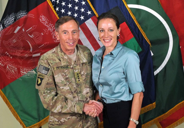   FILE -- This July 13, 2011, photo made available on the International Security Assistance Force's Flickr website shows the former Commander of International Security Assistance Force and U.S. Forces-Afghanistan Gen. Davis Petraeus, left, shaking hands with Paula Broadwell, co-author of 