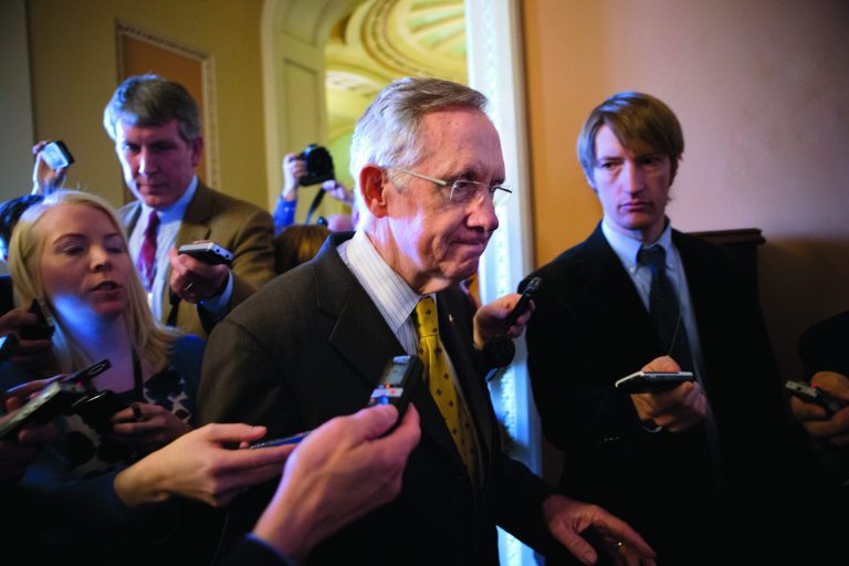Senate Majority Leader Harry Reid, D-Nev., walks to a closed-door meeting with fellow Democrats as he and Senate Minority Leader Mitch McConnell, R-Ky., work to negotiate a legislative path to avoid the so-called 