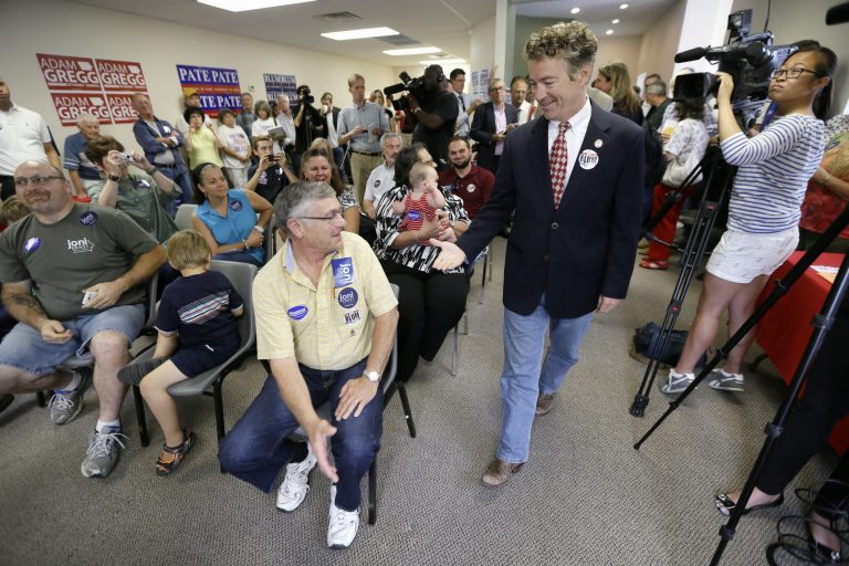 Sen. Rand Paul is greeted by local Republicans before speaking at a gathering for local candidates Tuesday in Hiawatha, Iowa. (AP Photo/Charlie Neibergall)