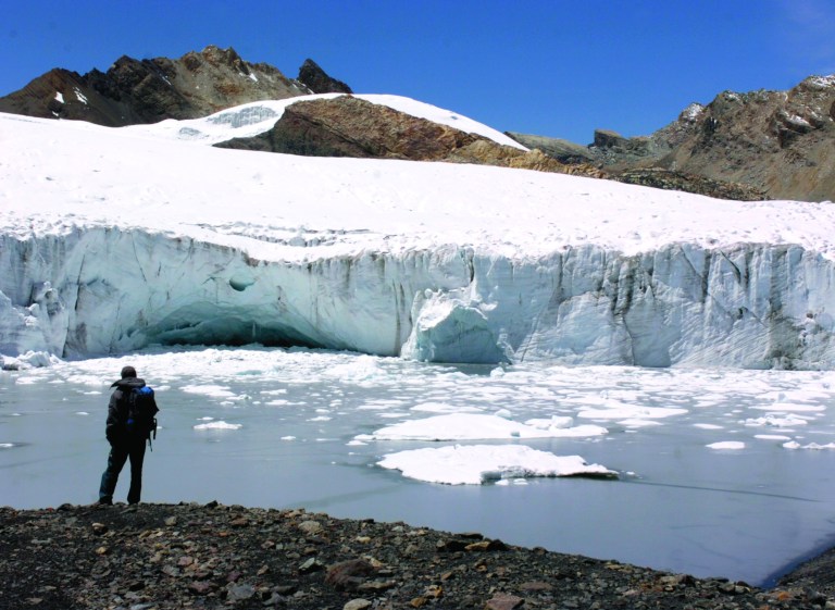 FILE - In this Nov. 4, 2006 file photo, an explorer looks looks out at the Pastoruri glacier, part of the Cordillera Blanca, or 