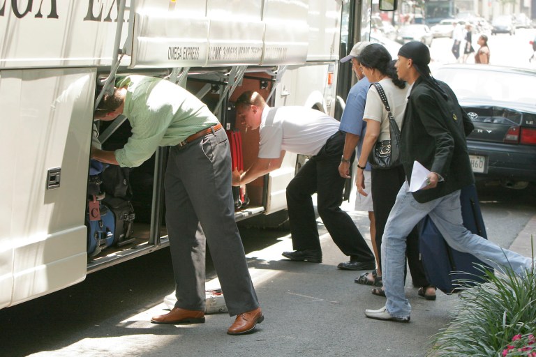 Passengers wait to board a 