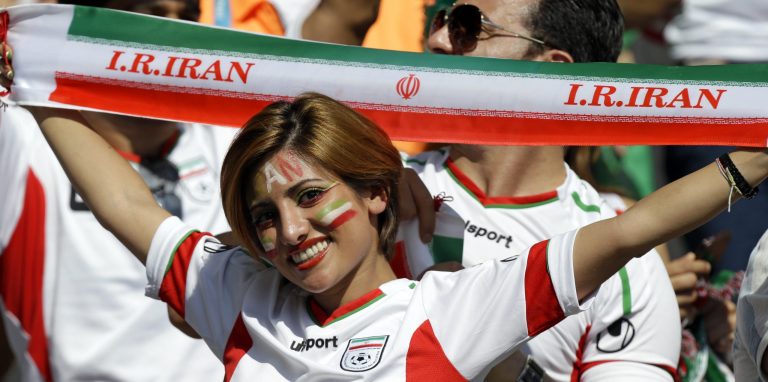 An Iranian supporter holds up a team banner before the group F World Cup soccer match between Argentina and Iran at the Mineirao Stadium in Belo Horizonte, Brazil, Saturday, June 21, 2014. (AP/Fernando Vergara)