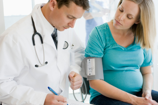 Doctor examining pregnant woman