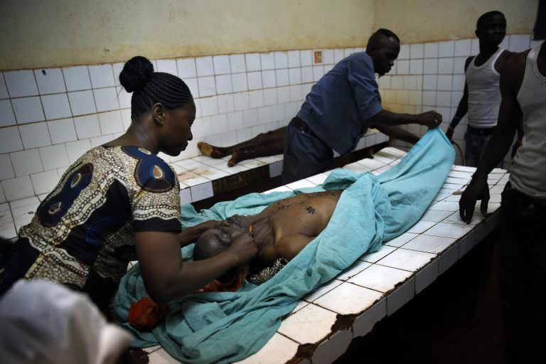Hospital workers clean the bodies of two of the victims of an attack on a Catholic Church in Bangui, Central African Republic, Wednesday May 28, 2014. Muslim rebels stormed a Catholic church compound in the capital of Central African Republic on Wednesday, killing as many as 30 people in a hail of gunfire and grenades, witnesses said. The attack on the compound at the Church of Fatima, where hundreds of civilians had sought refuge from the violence ravaging Bangui's streets, is the largest blamed on Muslim fighters since their Seleka coalition was ousted from power nearly five months ago. (AP Photo/Jerome Delay) FRANCE OUT ONLINE OUT
