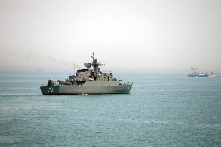 In this picture taken on Tuesday, April 7, 2015, and released by the semi-official Fars News Agency, Iranian warship Alborz, foreground, prepares before leaving Iran's waters, at the Strait of Hormuz. (AP Photo/Fars News Agency, Mahdi Marizad)