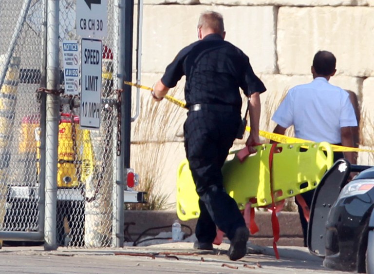 Emergency workers head in to Totall Metal Recycling in Granite City, Ill., Monday morning, Aug. 25, 2014, following an explosion at the recycling plant. Police say two people are dead and more are injured after an explosion. Officials fear more explosions, perhaps from live ammunition rounds. (AP Photo/Belleville News-Democrat, Derik Holtmann)