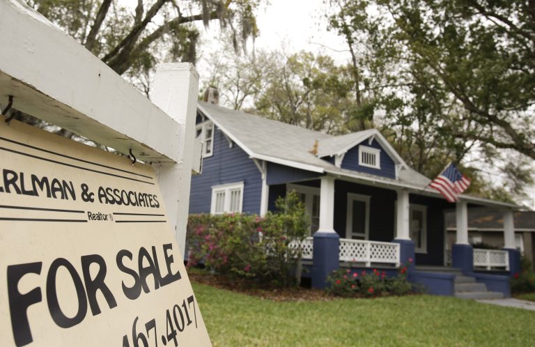 FILE- In this March 7, 2014, file photo, a realty sign hangs in front of a home for sale in Orlando, Fla. Standard & Poor's releases the S&P/Case-Shiller index of home prices for April on Tuesday, June 24, 2014. (AP Photo/John Raoux, File)