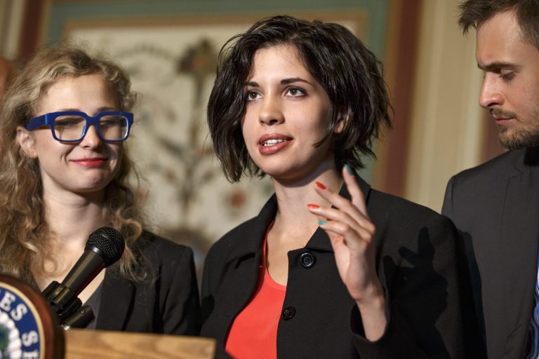 Russian political activists Nadya Tolokonnikova, center, and Maria Alyokhina, left, of the Russian punk band Pussy Riot, join Sen. Ben Cardin, D-Md., the chairman of the Helsinki Commission in seeking action to stop violations of human rights by pro-Russian militants in the Ukraine region, at the Capitol in Washington, Tuesday, May 6, 2014. At right is Pyotr Verzilov, Nadya Tolokonnikova's husband who helped to interpret. The political activists spent more than a year behind bars for performing songs critical of Russian leader Vladimir Putin. (AP Photo/J. Scott Applewhite)