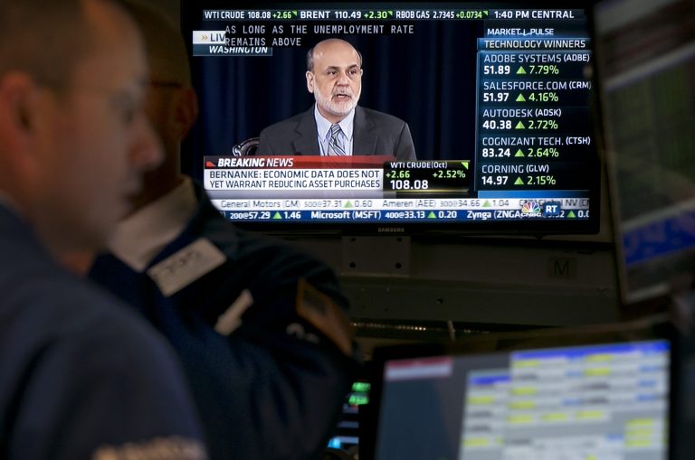 The news conference of Fed Chairman Ben Bernanke appears on a television screen at a post on the floor of the New York Stock Exchange Wednesday, Sept. 18, 2013. The Federal Reserve has decided against reducing its stimulus for the U.S. economy, saying it will continue to buy $85 billion a month in bonds because it thinks the economy still needs the support. (AP Photo/Richard Drew)