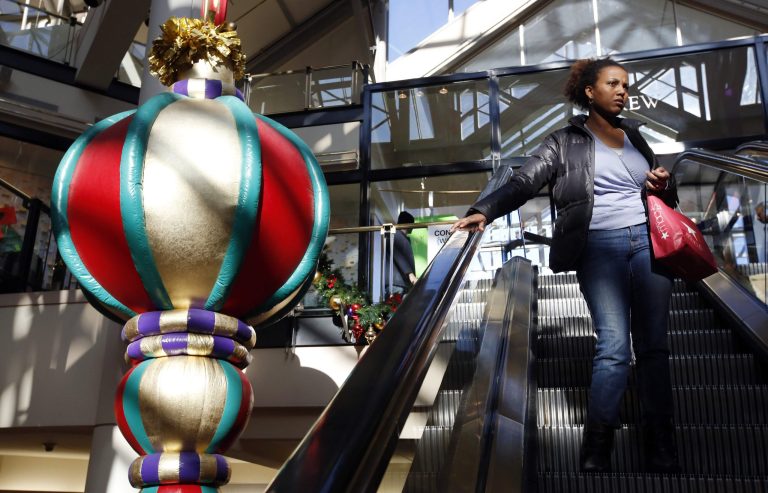   A woman rides the escalator past a giant holiday ornament at the CambridgeSide Galleria mall in Cambridge, Mass., Monday, Dec. 24, 2012. Although fresh data on the holiday shopping season is expected in coming days, early figures point to a ho-hum season for retailers despite last-ditch efforts to lure shoppers over the final weekend before Christmas. And with concerns about the economy and the looming âfiscal cliffâ weighing on the minds of already cautious shoppers, analyst say stores will need to offer âonce in a lifetimeâ blowouts to clear out inventory. (AP Photo/Michael Dwyer)  