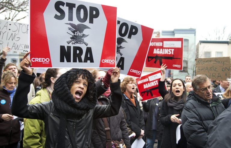   Tasha Devoe, left, of Lawrence, Mass., joins a march to the National Rifle Association headquarters on Capitol Hill in Washington Monday, Dec. 17, 2012. Curbing gun violence will be a top priority of President Barack Obama's second term, aides say. but exactly what he'll pursue and how quickly are still evolving. (AP Photo/Manuel Balce Ceneta)  