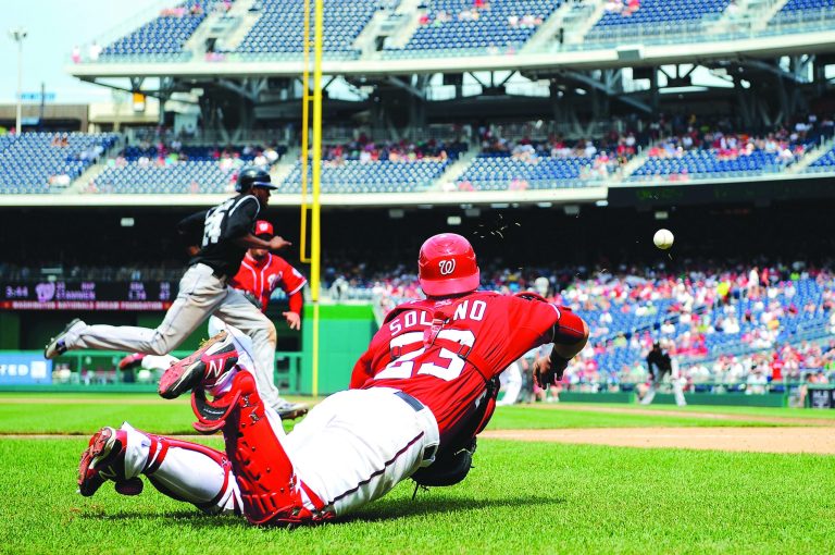 Patrick McDermott/Getty Images
Dexter Fowler scored the tying run after Jhonatan Solano couldn't retrieve a wild pitch, one of two uncorked by the Nationals.
