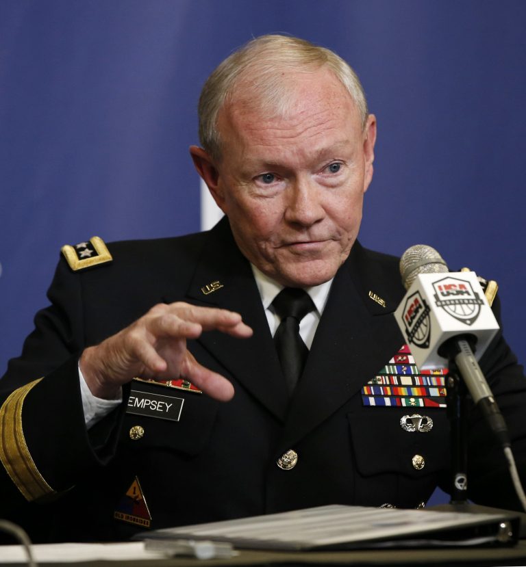 FILE - This Aug. 20, 2014 file photo shows Joint Chiefs Chairman Gen. Martin Dempsey speaking at Madison Square Garden in New York. During a Pentagon briefing Thursday, Dempsey said it's possible to contain the Islamic State militants, but it can't be done permanently without going after the group in Syria. Speaking to reporters with Defense Secretary Chuck Hagel, Dempsey said he wasn't predicting U.S. airstrikes in Syria, but said the problem must be addressed diplomatically, politically and militarily by America and its regional partners.   (AP Photo/Kathy Willens, File)
