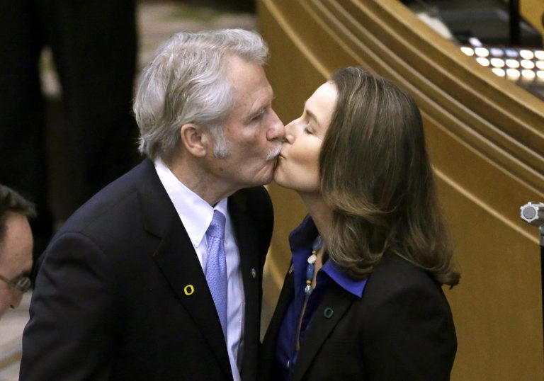Oregon Gov. John Kitzhaber kisses his fiancee, Cylvia Hayes, after he is sworn in for an unprecedented fourth term as governor in Salem, Ore. Kitzhaber announced his resignation Friday, Feb. 13, 2015, amid allegations Hayes used her relationship with him to enrich herself. (AP Photo/Don Ryan, File)