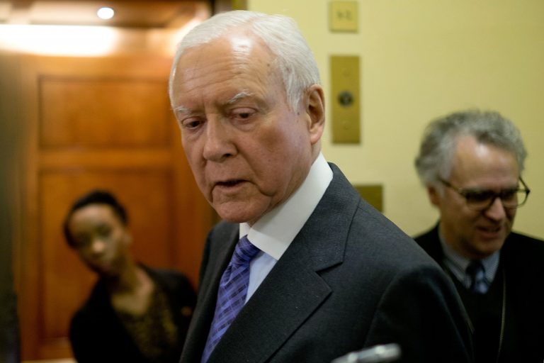 Orrin Hatch talks with reporters on his way to the Senate Chamber on April 3, 2014 in Washington. (Photo by T.J. Kirkpatrick/Getty Images)
