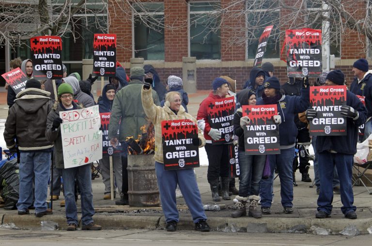 Blood collection workers picket in front of the American Red Cross in Cleveland. (AP)