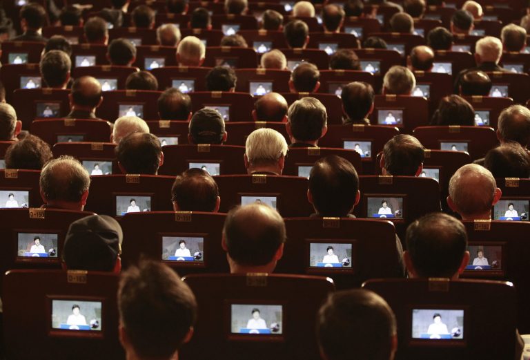 Small screens show South Korean President Park Geun-hye as participants listen to her speech during a ceremony to celebrate the March First Independence Movement Day, the anniversary of the 1919 uprising against Japanese colonial rule, in Seoul, South Korea, Saturday, March 1, 2014. (AP Photo/Ahn Young-joon)