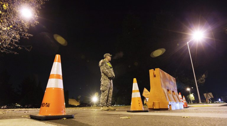 A soldier stands guard Friday Nov. 9, 2012, near the building housing a military courtroom on Joint Base Lewis McChord in Washington state, where a preliminary hearing was held for U.S. Army Staff Sgt. Robert Bales. (AP Photo/Ted S. Warren)