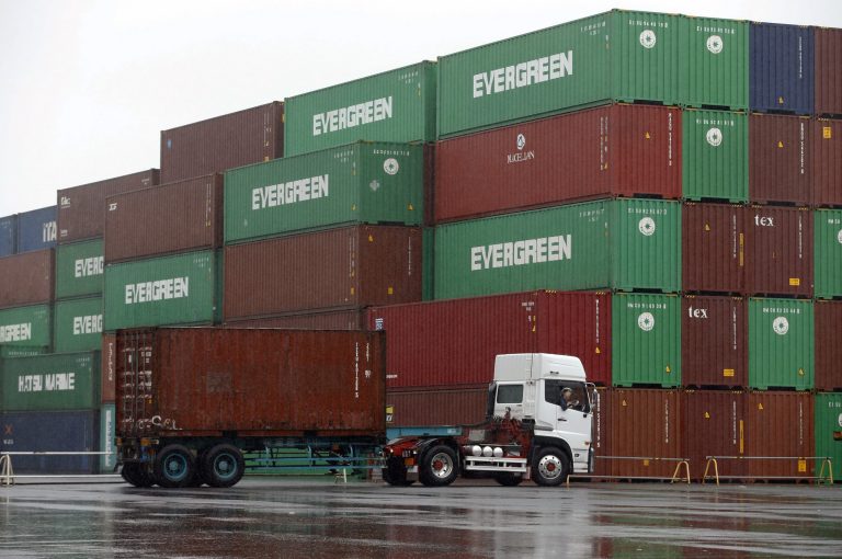 FILE - In this May 21, 2014 file photo, a truck leaves a container terminal in Tokyo. apan logged its 23rd successive month of trade deficits in May, as exports and imports both declined despite signs of recovering demand in the U.S. and Europe. (AP Photo/Shizuo Kambayashi, File)