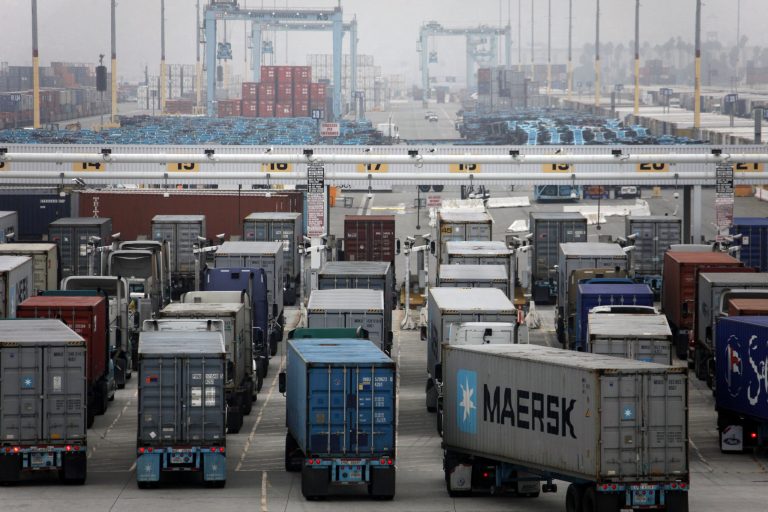   Trucks wait to be loaded at the Port of Los Angeles Wednesday, Dec. 5, 2012 in Los Angeles. Work resumed Wednesday at the Los Angeles and Long Beach harbors after settlement of a strike that crippled the nation's busiest container port complex for more than a week. (AP Photo/Nick Ut)  