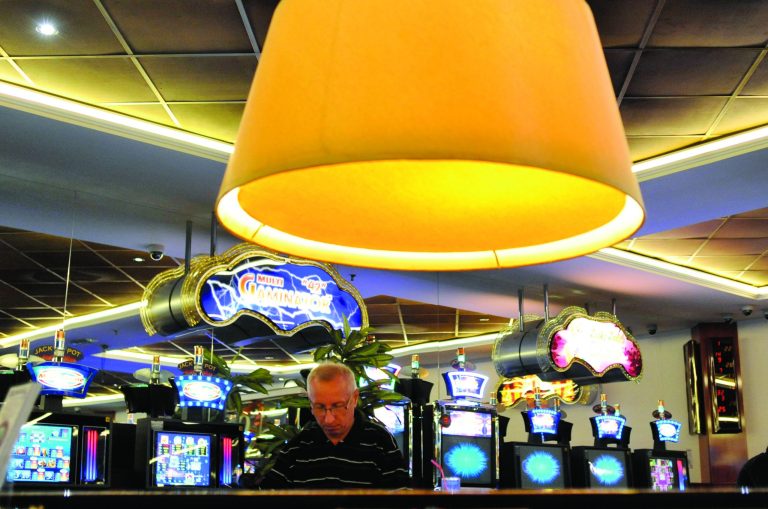 A man plays slot machine roulette in a gambling hall in Budapest, Hungary, Wednesday, Oct. 3, 2012. Hungary's ban on slot machines has taken the country's gambling industry by surprise. On Tuesday, just over 24 hours after the announcement, lawmakers in the Hungarian Parliament voted in favor of a new bill which bans the country's slot machines. (AP Photo/Bela Szandelszky)
