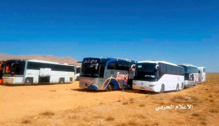 About 300 fighters and almost as many family members are on buses being evacuated under the controversial deal, which was brokered to end the presence of ISIS along the Lebanon-Syria border. (Syrian Central Military Media, via AP)