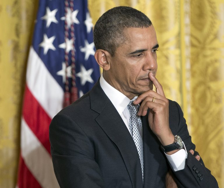 In this April 3, 2014, photo, President Barack Obama listens on stage before speaking about the shooting at Fort Hood, during an event welcoming members of the U.S. teams from the 2014 Winter Olympic and Paralympic Winter Games in Sochi, Russia in the East Room of White House in Washington.  The roller coaster of health care enrollment behind him, Obama is using a lull between foreign travel to refocus on his economic agenda, using executive actions to push for greater gender pay equality and to promote better technical skills for U.S. students.(AP Photo/Pablo Martinez Monsivais)