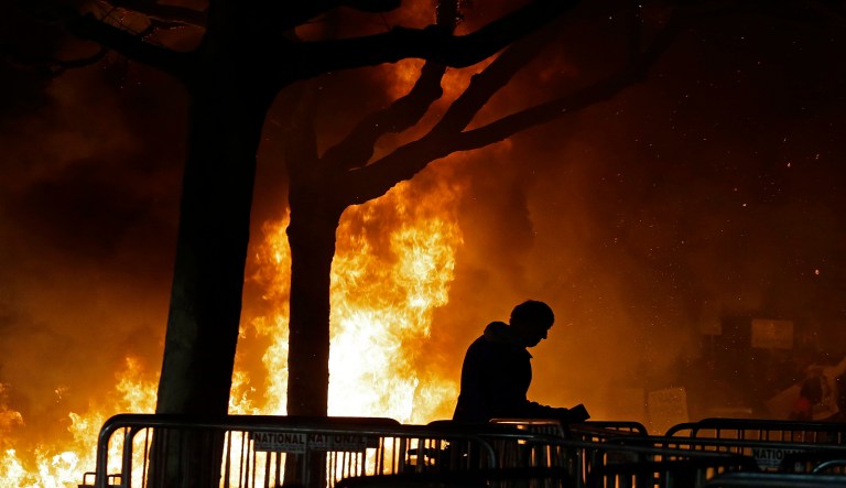 FILE - In this Feb. 1, 2017 file photo, a fire set by demonstrators protesting a scheduled speaking appearance by Breitbart News editor Milo Yiannopoulos burns on Sproul Plaza on the University of California, Berkeley campus. UC Berkeley police took a hands-off approach to protesters on the campus last week when violent rioters overtook a largely peaceful protest against a controversial speaker. But that response is being questioned as demonstrators become increasingly hostile and politics are more polarized. (AP Photo/Ben Margot, File)