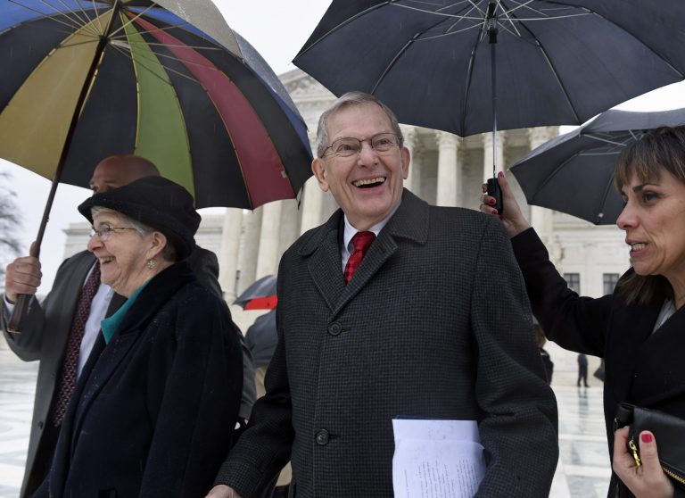 Good News Community Church Pastor Clyde Reed, center, smiles as he leaves the Supreme Court in Washington, Monday, Jan. 12, 2015, with his wife Ann, left. Associated Press file photo.Â 