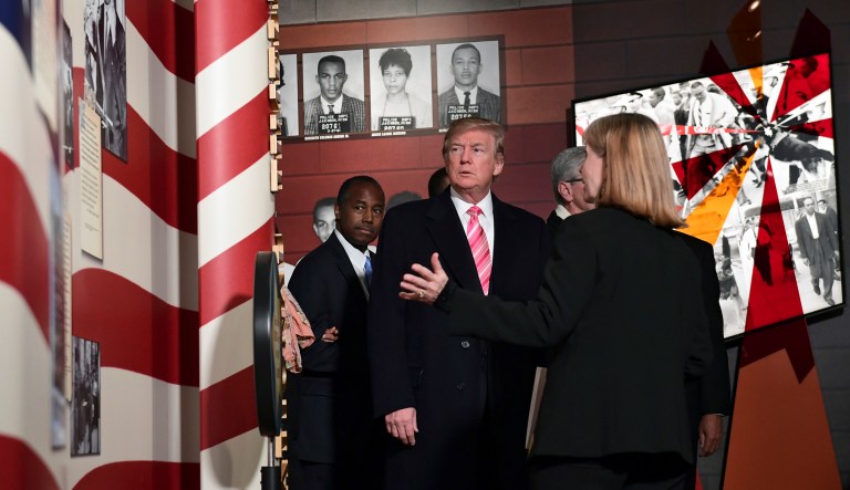 President Donald Trump gets a tour of the newly-opened Mississippi Civil Rights Museum in Jackson, Miss., Saturday, Dec. 9, 2017. Housing and Urban Development Secretary Ben Carson, left, joins the president on the tour. (AP Photo/Susan Walsh)