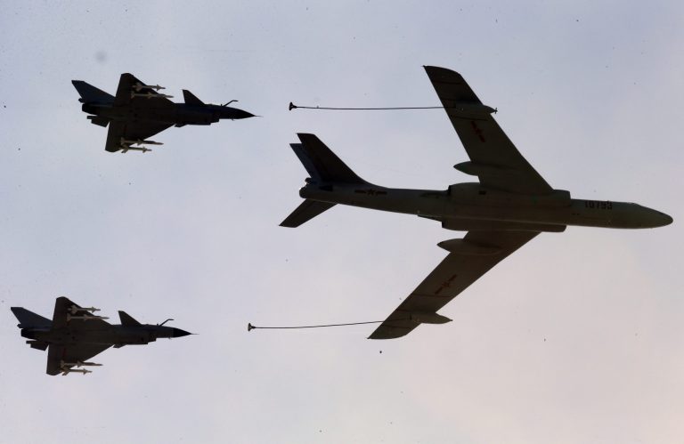 A Chinese military refueling tanker flies with fighter jets during a parade commemorating the 70th anniversary of Japan's surrender during World War II held in front of Tiananmen Gate in Beijing, Thursday, Sept. 3, 2015. (AP Photo/Ng Han Guan)