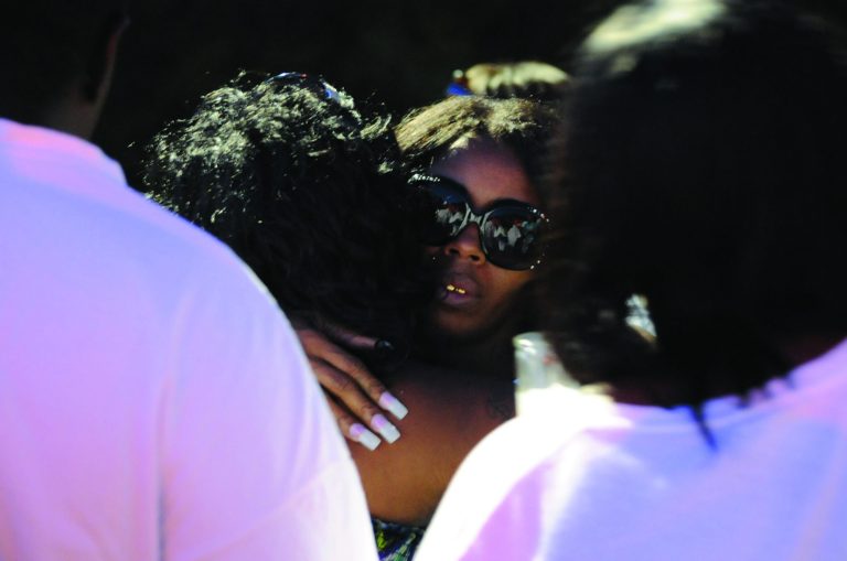 FILE - In this Aug. 6, 2012 file photo, Teresa Carter, mother of Chavis Carter, is hugged by supporters following a candlelight vigil held in Jonesboro, Ark. An autopsy report released Monday, Aug. 20, 2012 lists the death of Chavis Carter as caused by the muzzle of a gun placed against his right temple when fired. The report said the manner of death was ruled a suicide based on autopsy findings and investigative conclusions from the Jonesboro police department. (AP Photo/The Jonesboro Sun, Krystin McClellan, File)
