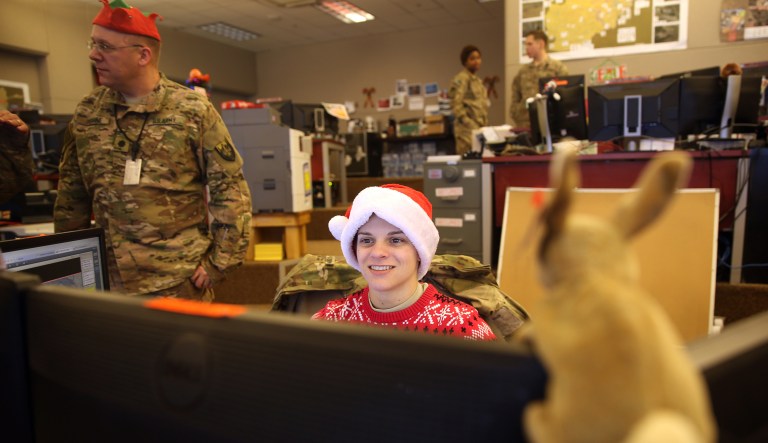 In this 2015 photo, U.S. soldiers work in their office on Christmas day at Bagram Air Field, north of Kabul, Afghanistan. While people back in the U.S. sit by the fire and open presents with their families, Christmas is just another day on duty for many soldiers, sailors, marines, and airmen. (AP Photo/Massoud Hossaini)