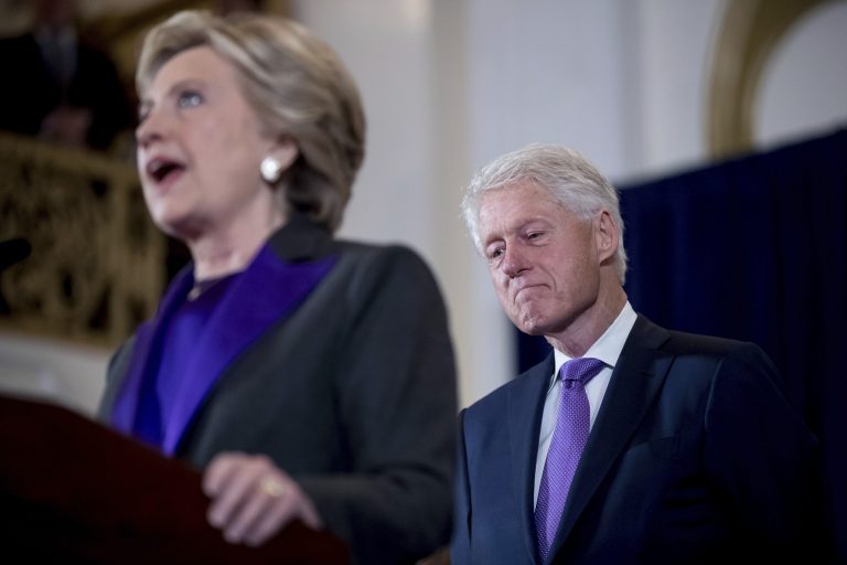 Former President Bill Clinton listens as his wife, Hillary Clinton, speaks to staff and supporters at the New Yorker Hotel in New York, Wednesday, Nov. 9, 2016, where she conceded her defeat to Republican Donald Trump after the hard-fought presidential election. (AP Photo/Andrew Harnik)