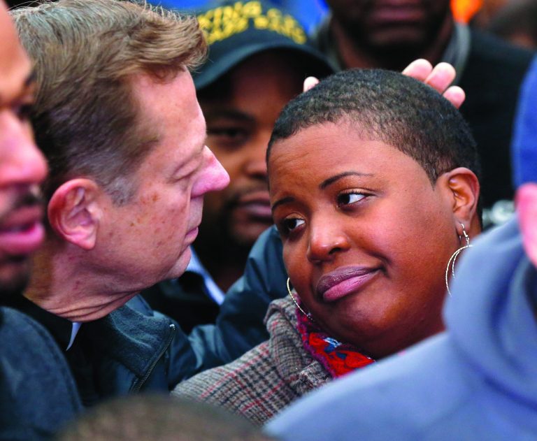 Father Michael Pfleger , left, consoles Cleopatra Pendelton during a news conference with Chicago Police Superintendent Garry McCarthy seeking help from the public in solving the murder of Pendelton's daughter Hadiya Wednesday, Jan. 30, 2013, in Chicago. Hadiya, 15, who had performed in President Barack Obama's inauguration festivities, was killed in a Chicago park as she talked with friends by a gunman who apparently was not even aiming at her. The city's 42nd slaying is part of Chicago's bloodiest January in more than a decade, following on the heels of 2012, which ended with more than 500 homicides for the first time since 2008. It also comes at a time when Obama, spurred by the Connecticut elementary school massacre in December, is actively pushing for tougher gun laws. (AP Photo/Charles Rex Arbogast)