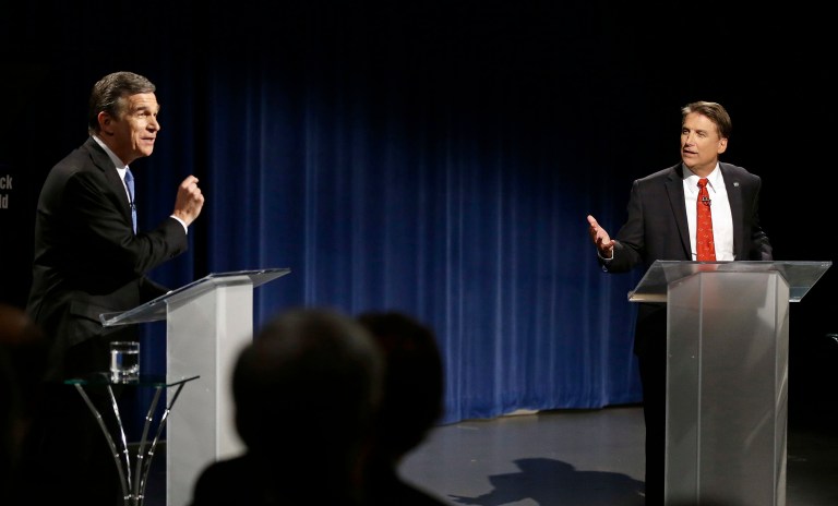 The state's incumbent Republican Gov. Pat McCrory, right, is in a heated-ballot counting battle with Democratic Attorney General Roy Cooper, the latter of whom has a 6,600-vote lead out of the 4.7 million ballots cast. (AP Photo/Gerry Broome, Pool)