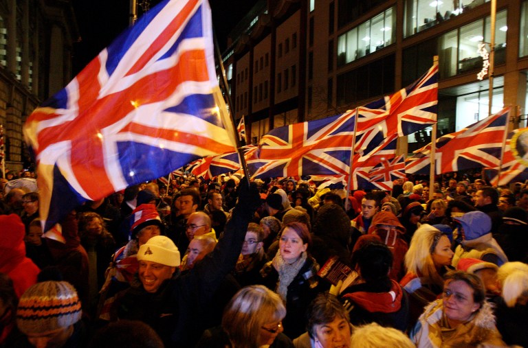   Loyalist protestors, some of them carrying British flags, gather as councillors debate whether or not to keep the flag flying at City Hall, outside City Hall, Belfast, Northern Ireland, Monday, Dec. 3, 2012. A Protestant mob stormed into the grounds of Belfast City Hall and clashed with police after the councilâs Catholic majority voted to remove the British flag from the building for most of the year. Authorities say two police officers and a security guard were wounded during Monday nightâs melee in the parking lot of the city hall. (AP Photo/PA, Paul Faith) UNITED KINGDOM OUT, NO SALES, NO ARCHIVE   