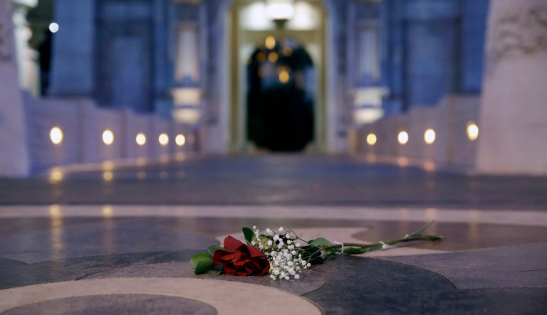 A single rose is left at the door of the Mandalay Bay hotel and casino in Las Vegas. A gunman opened fire at an outdoor music concert on Sunday. It was the deadliest mass shooting in modern U.S. history. (AP Photo/John Locher)