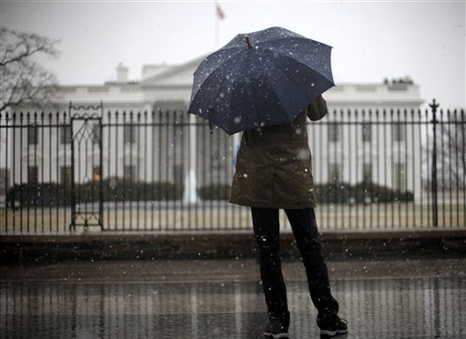   A tourist stops in front of the White House in Washington, Wednesday, March 6, 2013. Area schools and many government offices in the Washington area are closed for the in anticipation of the snow that could blanket the region. (AP Photo/Pablo Martinez Monsivais)