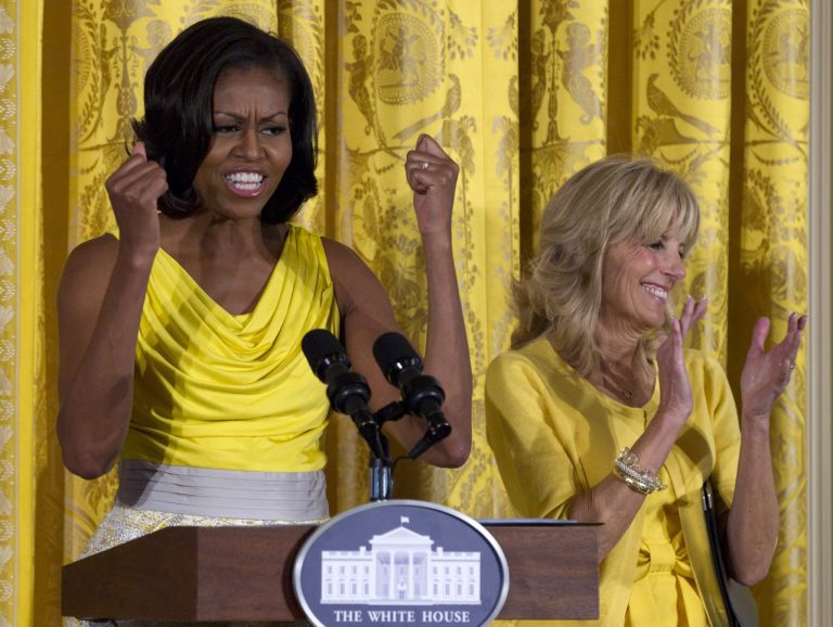 FILE - In this May 10, 2012, file photo, first lady Michelle Obama, accompanied by Jill Biden speaks at a Joining Forces event in honor of military mothers in the East Room of the White House in Washington. Michelle Obama and Jill Biden are getting some high-profile support for their initiative to help military families. They are being joined at the White House on Friday by former first lady Rosalynn Carter and former Sen. Elizabeth Dole for an announcement about support for the caregivers of wounded service members and veterans. (AP Photo/Carolyn Kaster, File)