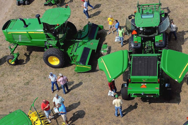 In this Aug. 19, 2014 photo, attendees to Dakotafest view the different farm machinery during the 3-day agricultural industry trade show in Mitchell, S.D. Agricultural equipment manufacturers and farmers say machinery sales have fallen recently because of lower commodity prices and changes to a federal tax break. (AP Photo/Argus Leader, Jay Pickthorn)