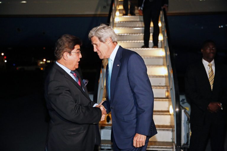 U.S. Secretary of State John Kerry, centre, talks with Afghanistan's Ministry of Foreign Affairs chief of protocol Ambassador Hamid Siddiq, as Kerry arrives at Kabul International airport in Kabul, Friday July 11, 2014. Kerry is expected to meet with Afghanistan's President Kharzai as well as both candidates in Afghanistan's recent presidential election.  (AP Photo/Jim Bourg, Pool)