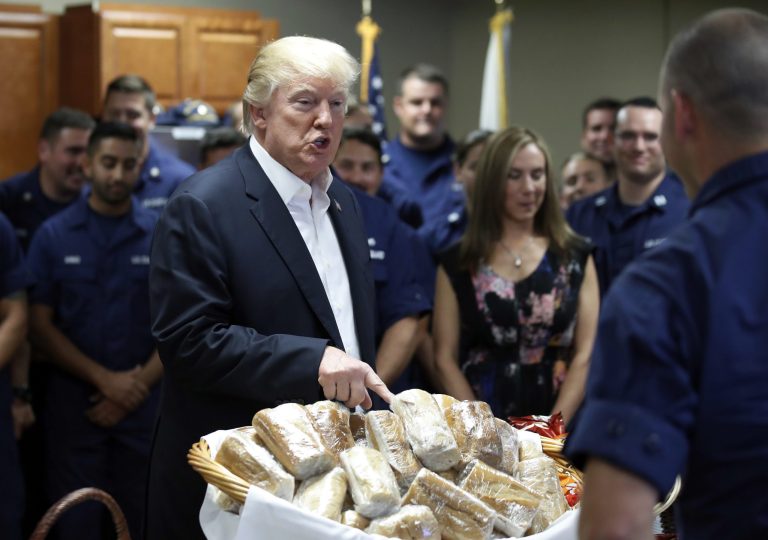President Donald Trump prepares to hand out sandwiches to members of the U.S. Coast Guard at the Lake Worth Inlet Station, on Thanksgiving, Thursday, Nov. 23, 2017, in Riviera Beach, Fla. (AP Photo/Alex Brandon)