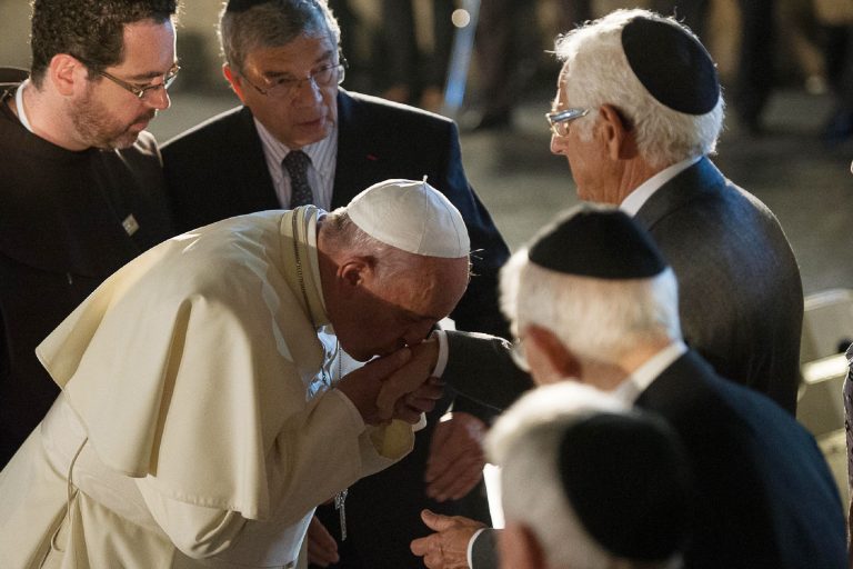 In this photo provided by the Vatican newspaper L'Osservatore Romano, Pope Francis kisses the hand of a Jewish men at the Hall of Remembrance on May 26, 2014, during his visit to the Yad Vashem Holocaust Memorial museum commemorating the six million Jews killed by the Nazis during World War II, in Jerusalem Monday, May 26, 2014.  (AP Photo/L'Osservatore Romano, ho)