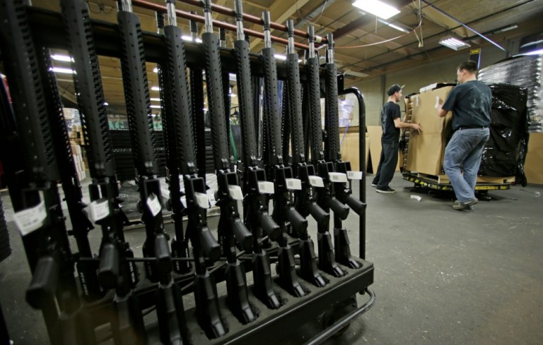 In short, a person can't simply walk into a gun store and legally purchase an AR-15, a 37mm attachment and a crate of grenades. None of this is mentioned in the Vox article or the graphic included in the story. (AP Photo)