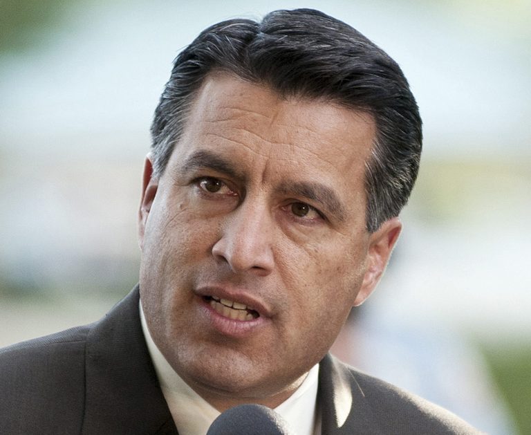 In a hypothetical, definitely make-believe matchup for U.S. Senate in 2016, Republican Gov. Brian Sandoval of Nevada would crush Senate Majority Leader Harry Reid by double digits, according to new polling data. (AP Photo)