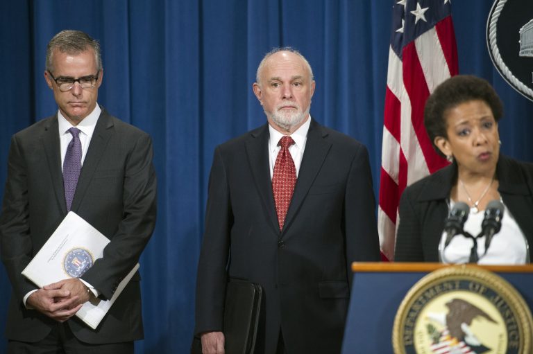FBI Assistant Director in Charge Andrew McCabe, Washington Field Office, left, and Assistant Attorney General Bill Baer, center, listens as Attorney General Loretta Lynch announces the big banks plead guilty to criminally manipulating global currency. (AP Photo)Â 